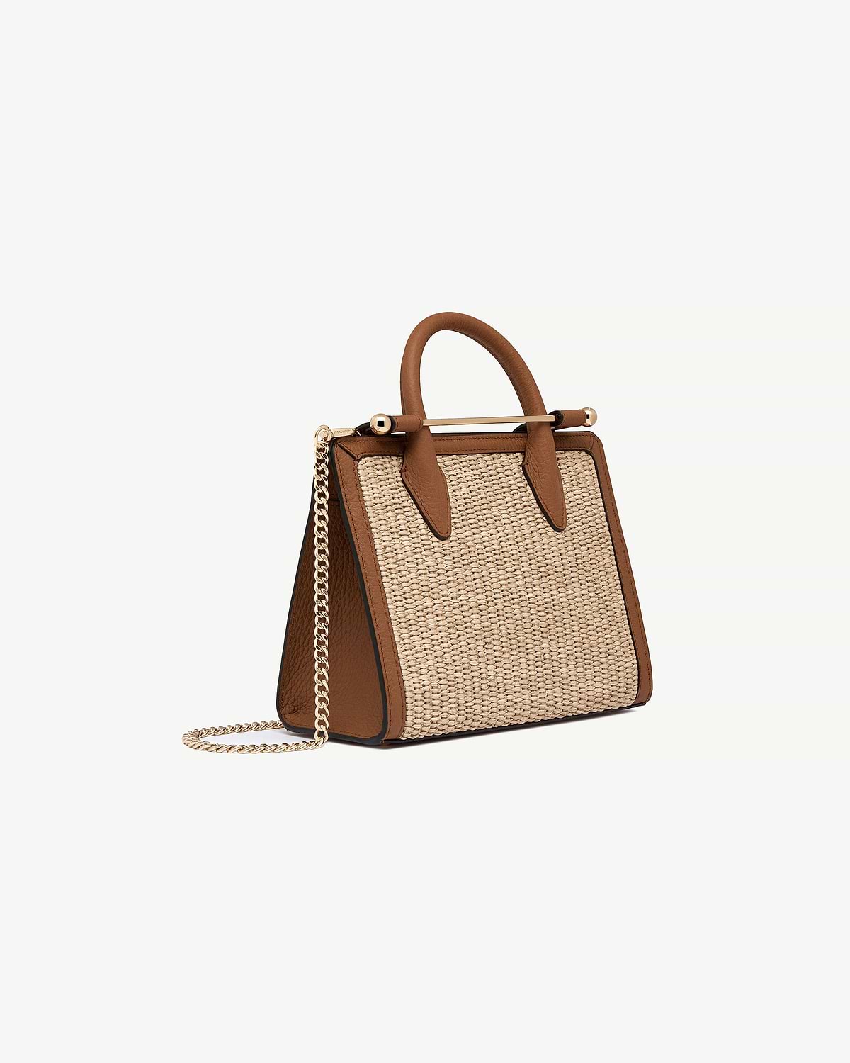 Tan leather-trim mini tote with natural raffia panels and gold chain strap.