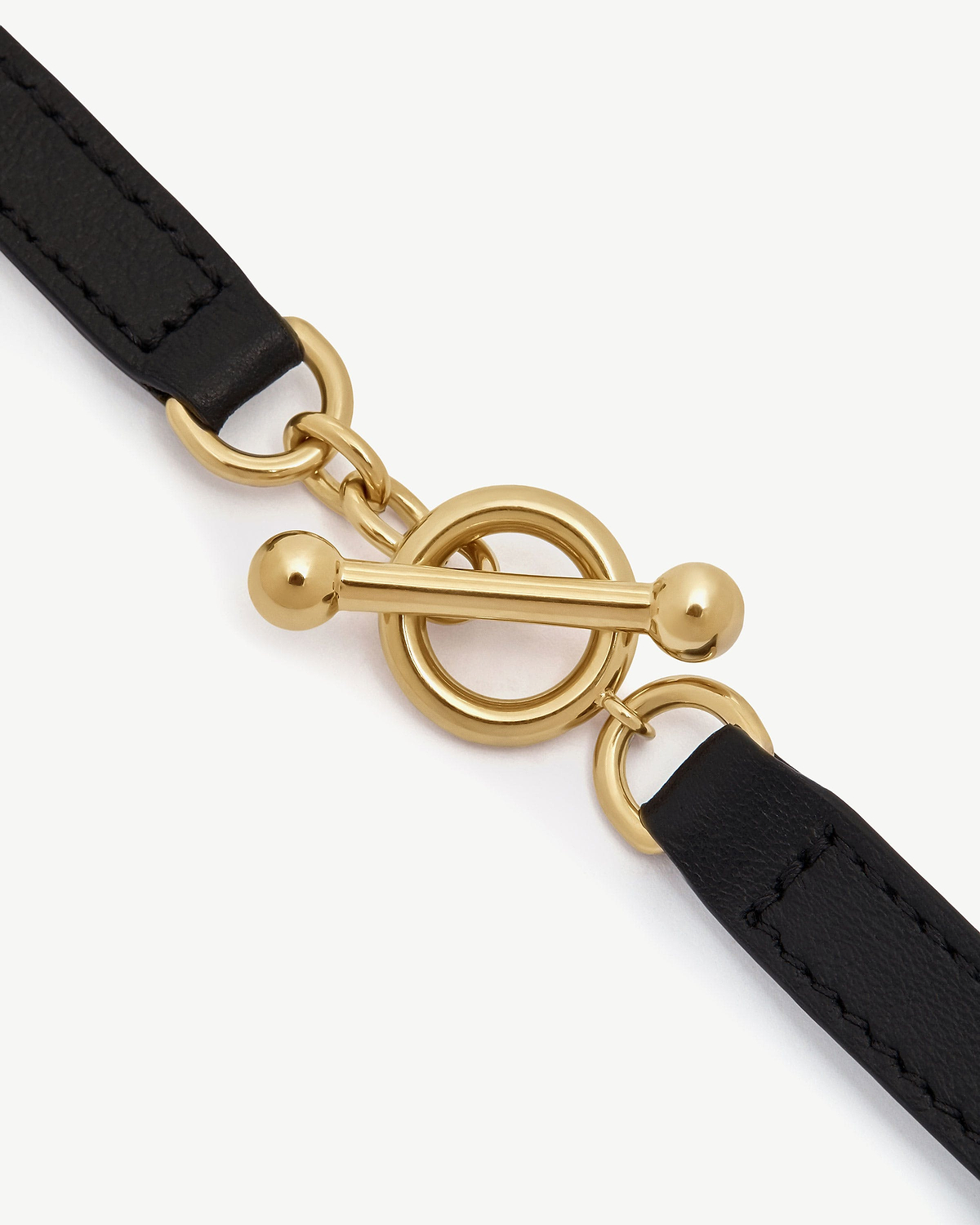 Black leather bracelet strap with gold toggle clasp and round links