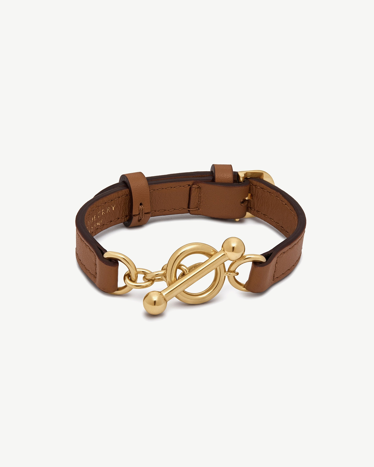 Tan leather bracelet with gold toggle clasp and circular chain links