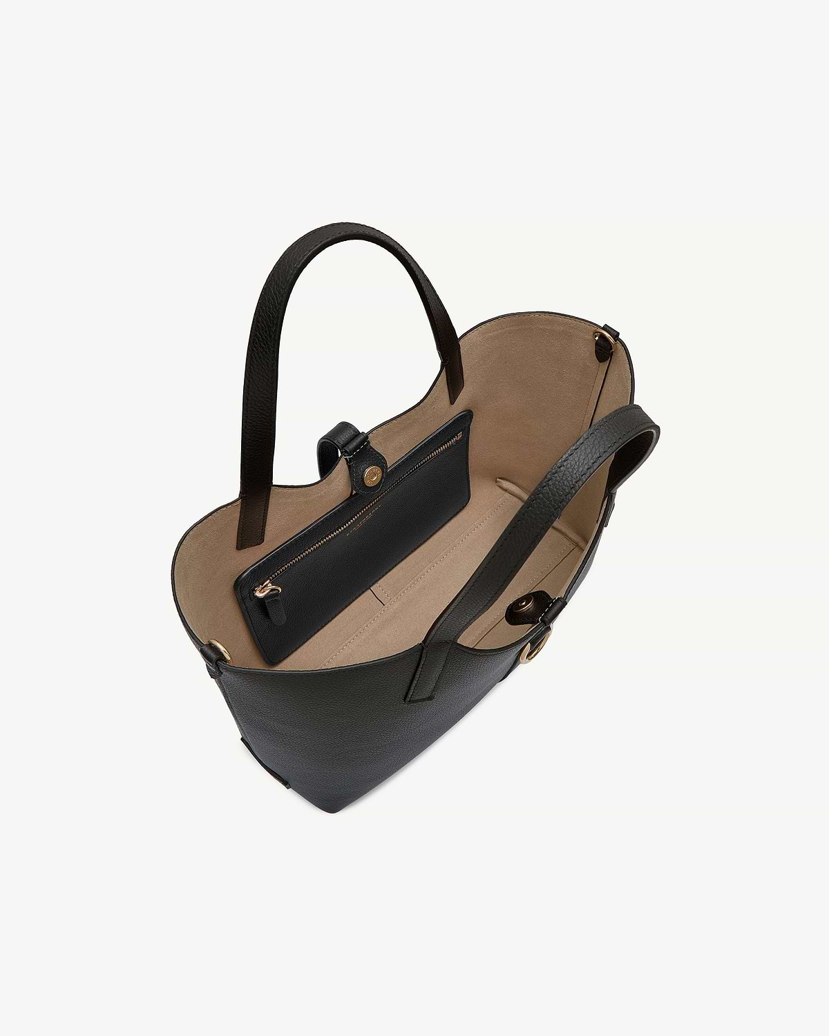 Black leather tote with two handles, beige interior, open top and zip pocket.