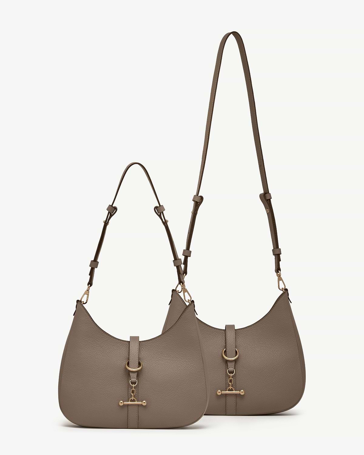 Two taupe kite sling bags with adjustable long and short straps and gold hardware.