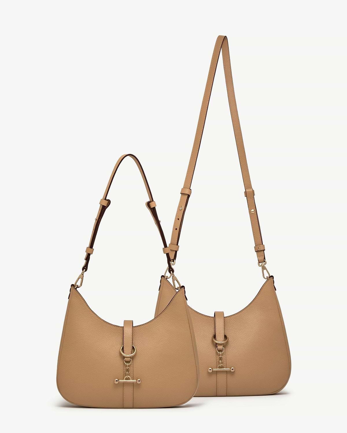 Two caramel kite sling bags with adjustable straps and gold-tone hardware.