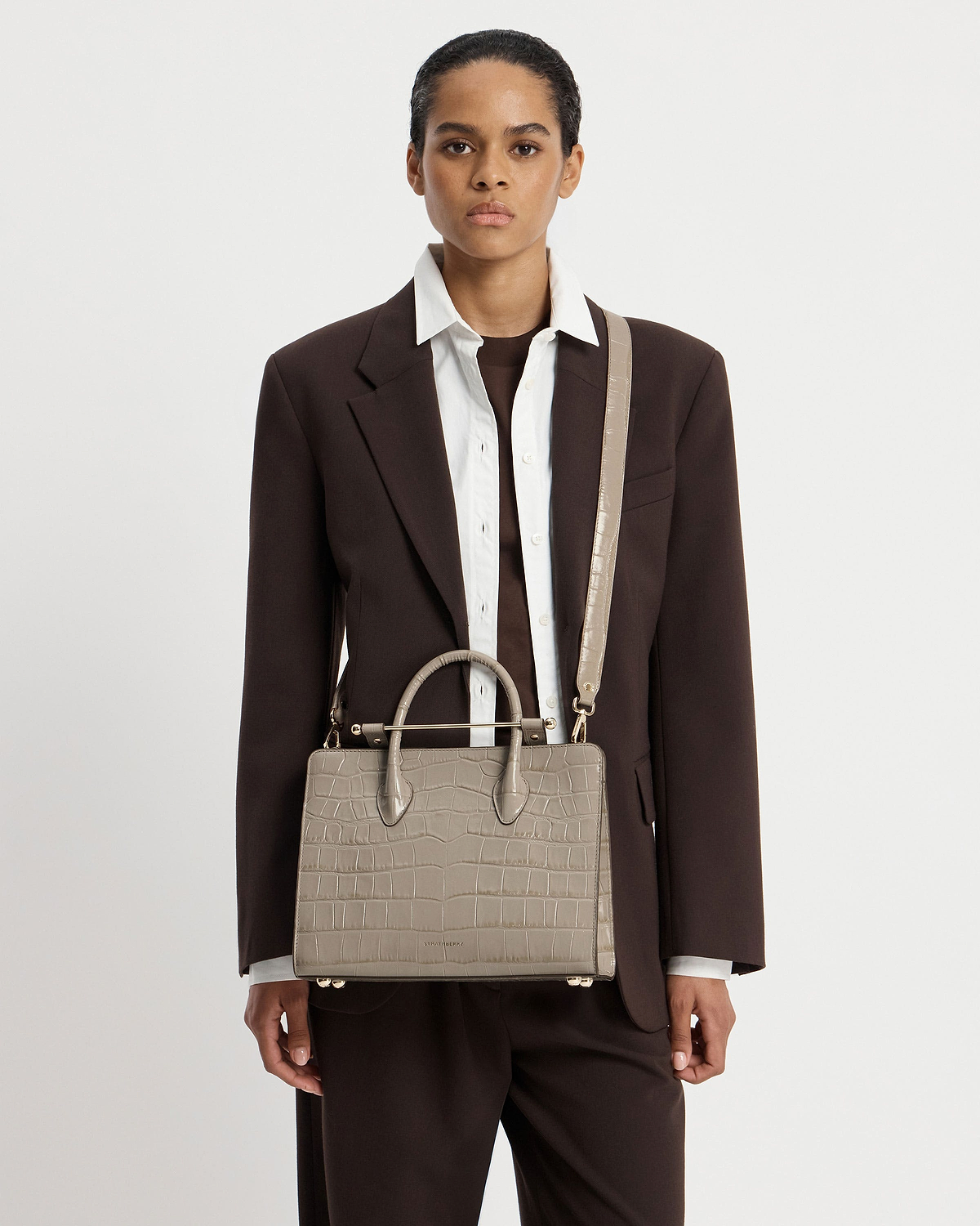 Model wearing Strathberry croc midi tote with top handles and shoulder strap