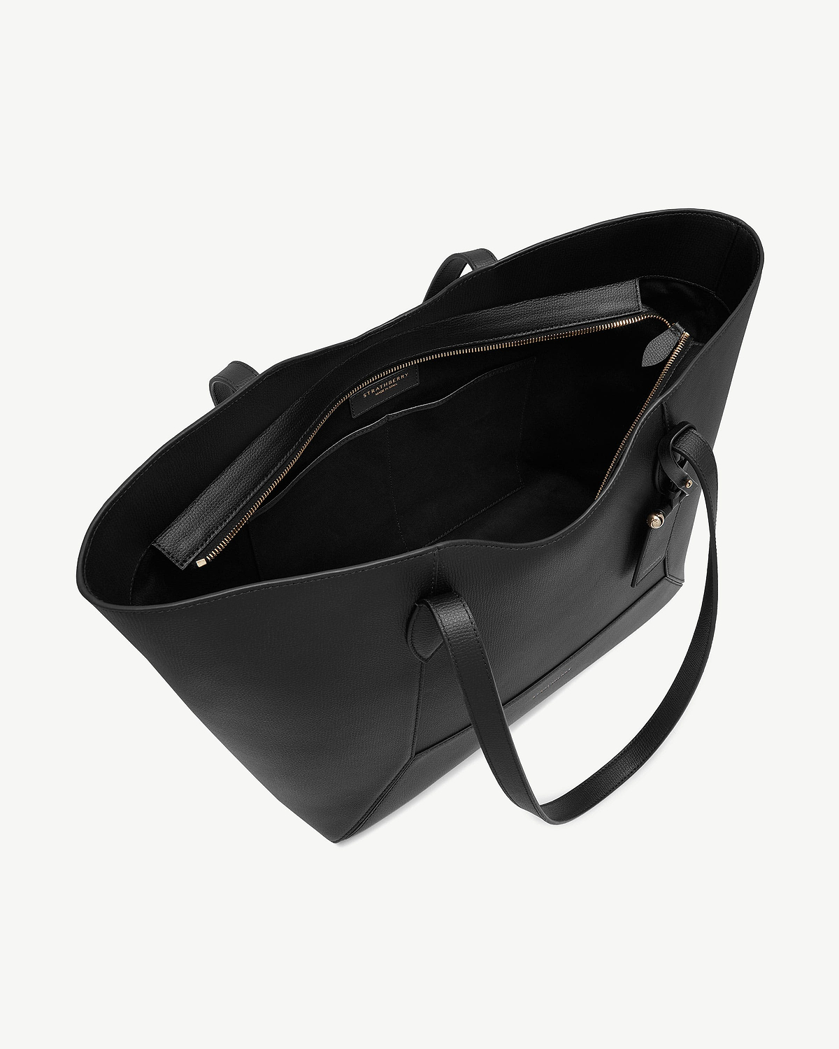 Black Mosaic Cabas tote open showing interior zip pocket and Strathberry label.
