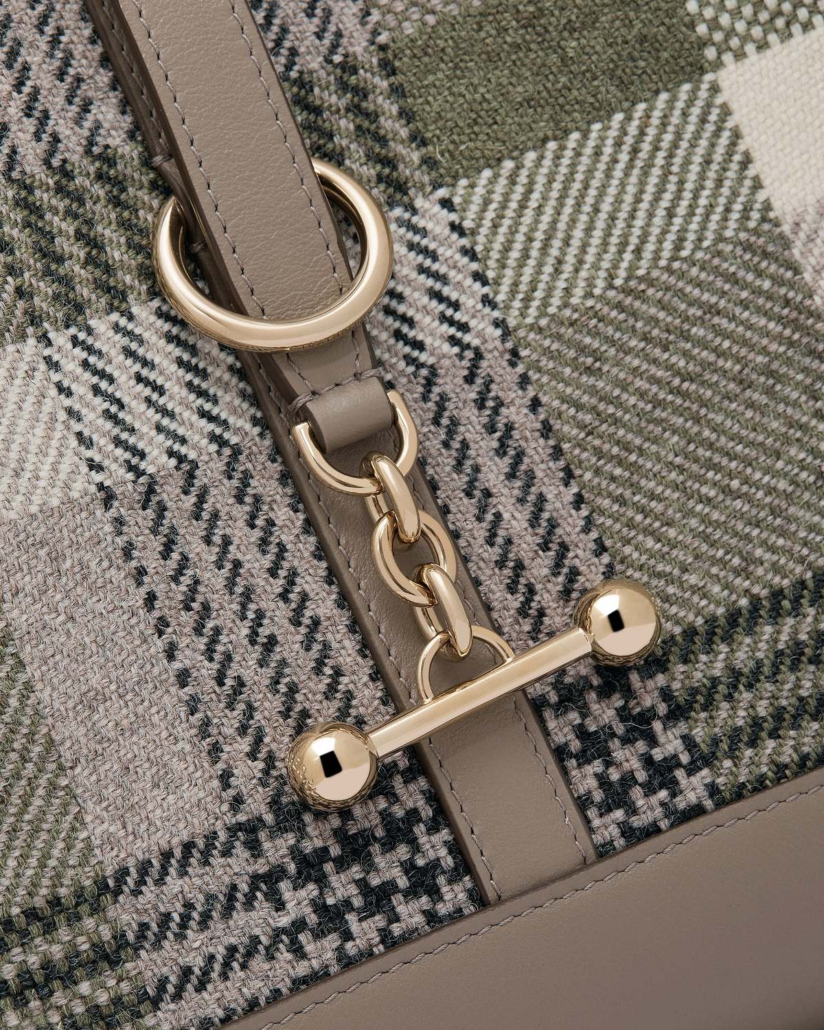 Tartan woven panel and taupe leather strap with gold chain and bar fastening.