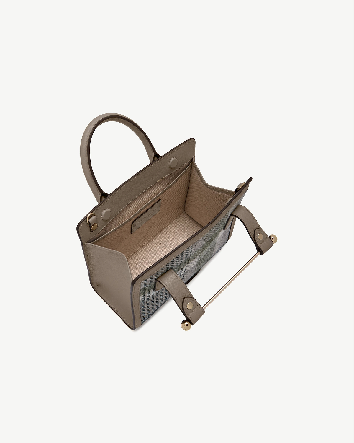 Mini tote with taupe leather trim and tartan exterior, open top showing interior.