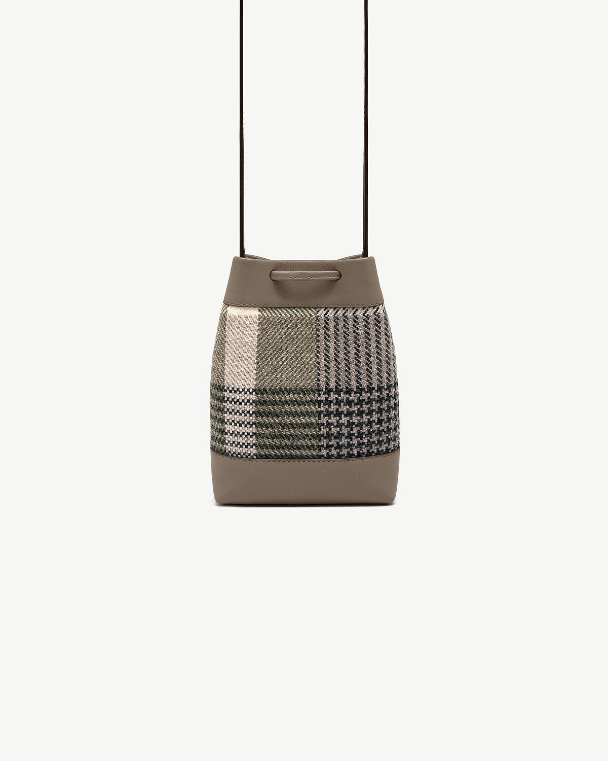 Tartan patchwork bucket pouch with taupe leather trim and thin shoulder strap.