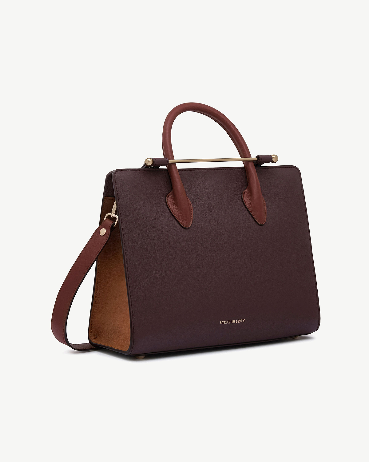 Burgundy leather midi tote with walnut interior, chestnut handles and Strathberry logo.