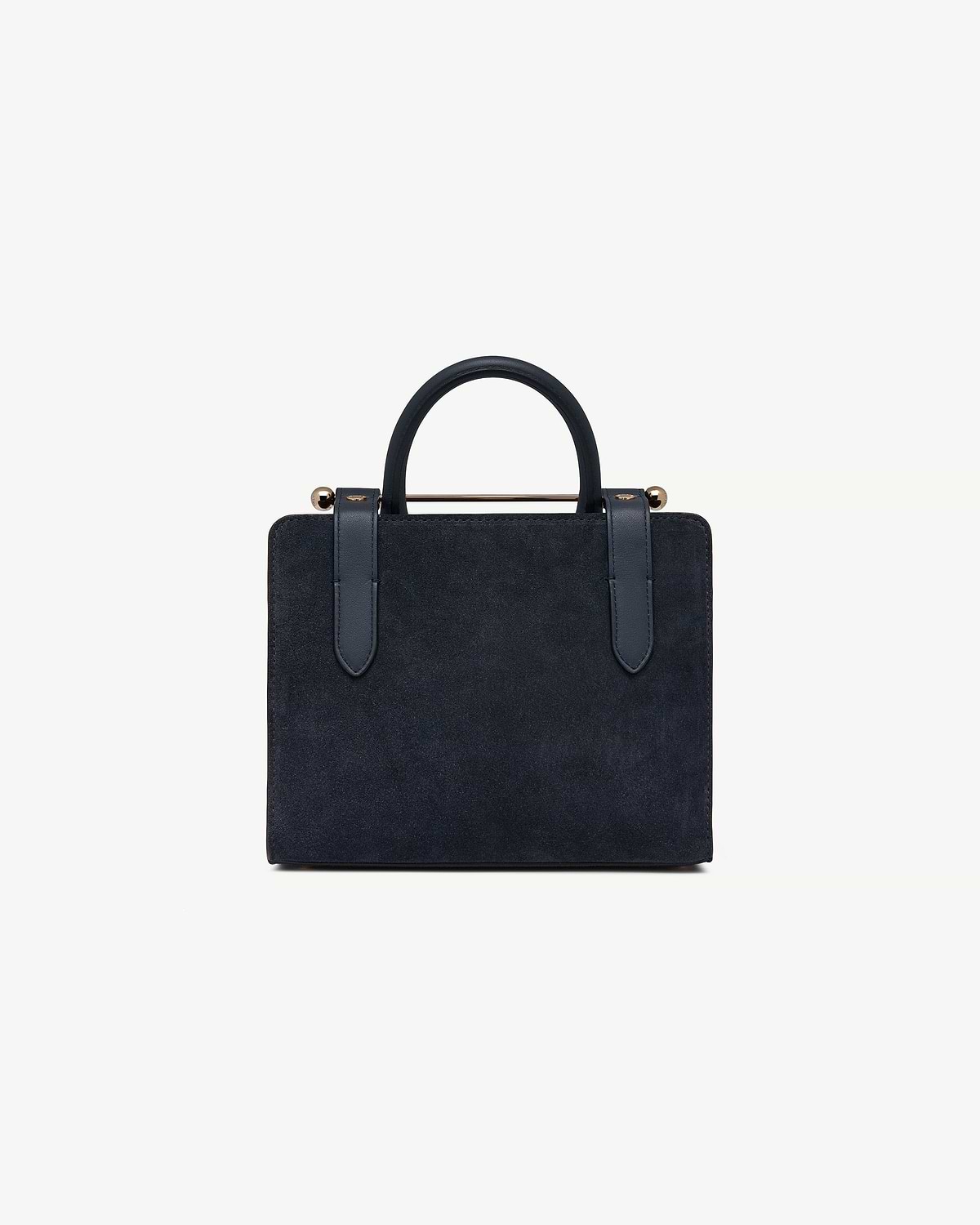 Navy suede mini tote with top handles and gold metal bar detail.