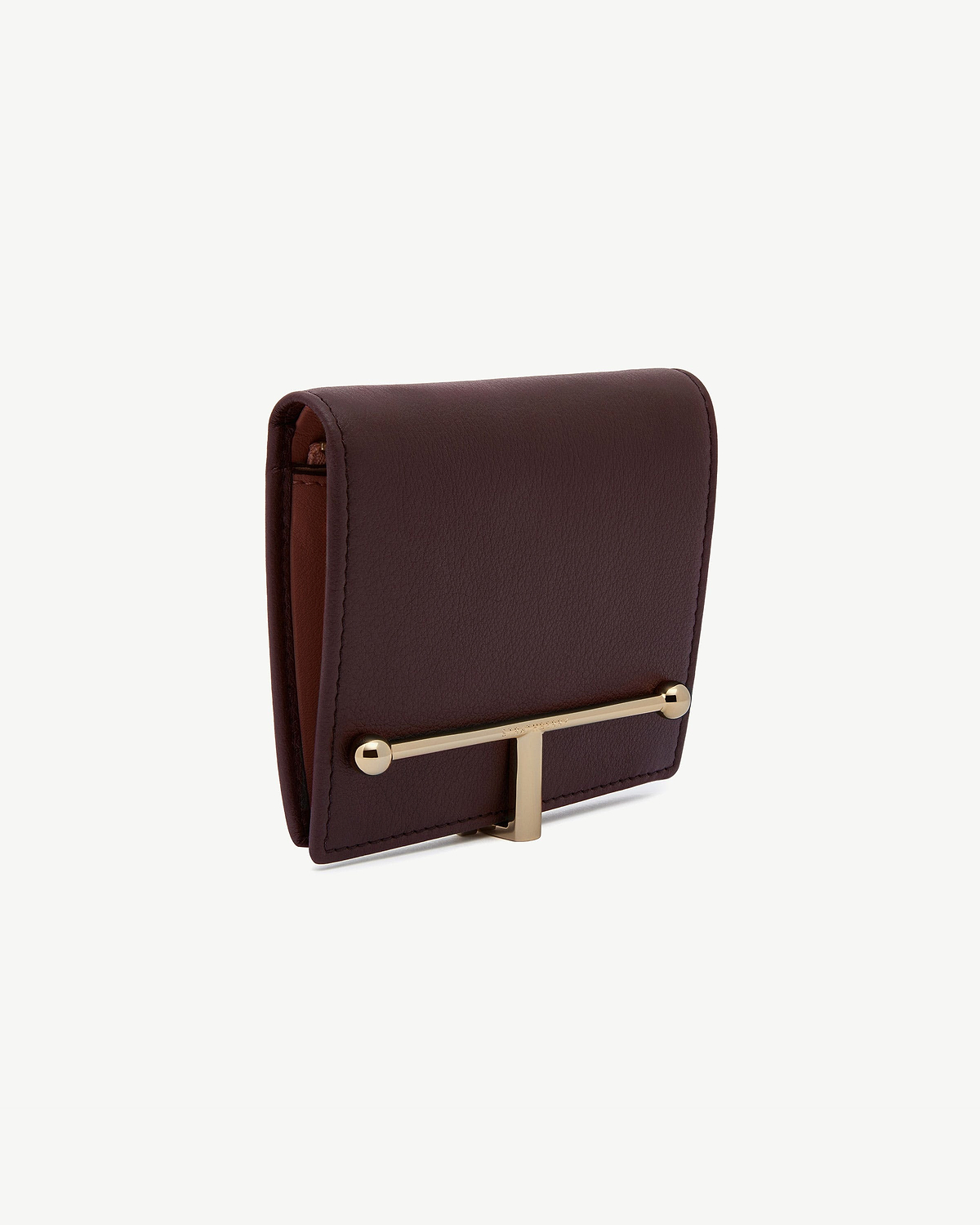 Burgundy and walnut leather wallet close-up showing gold T-bar hardware.