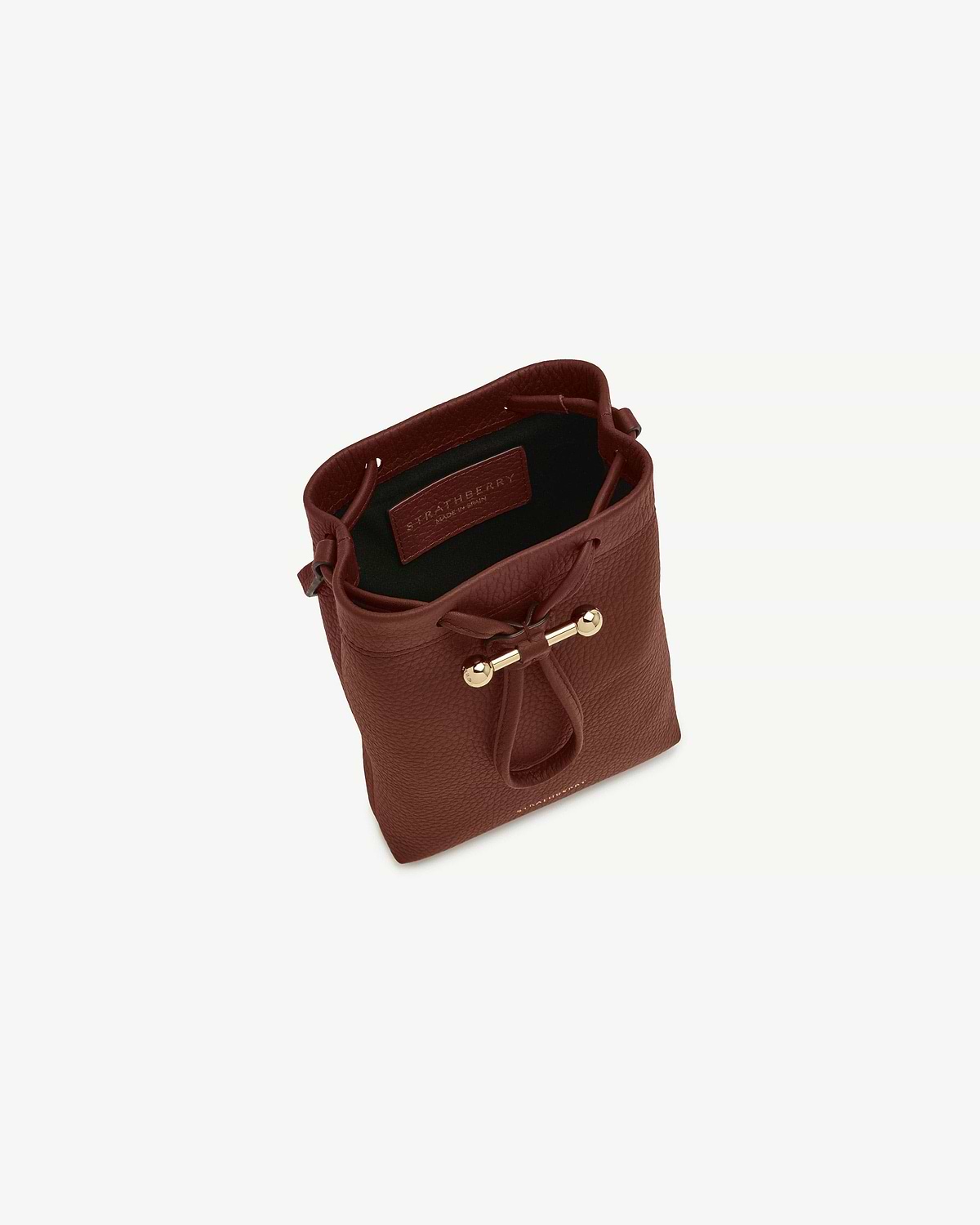 Walnut Strathberry Osette Midi pouch with drawstring top and gold bar detail.