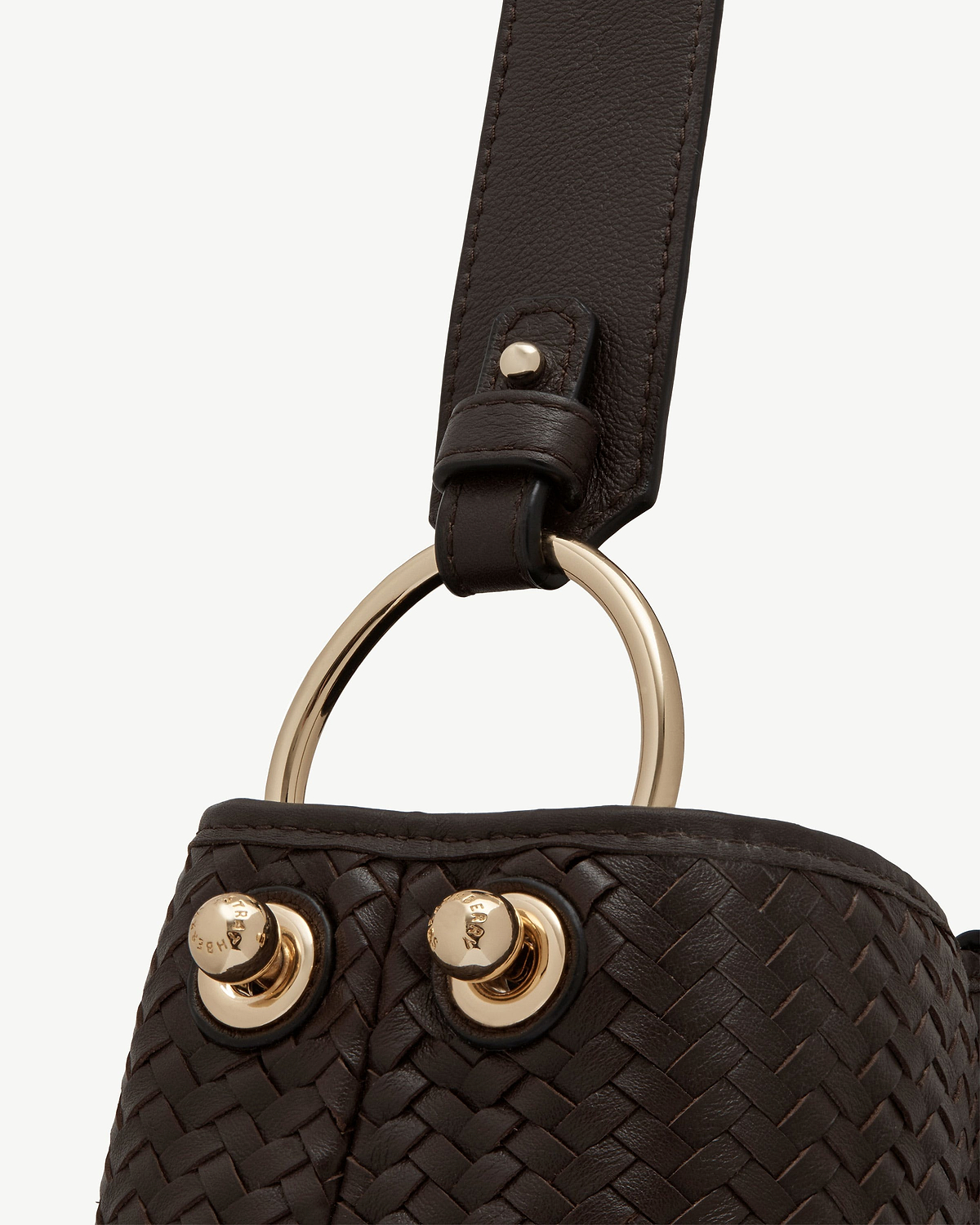 Chocolate woven leather strap with gold ring and stud hardware.