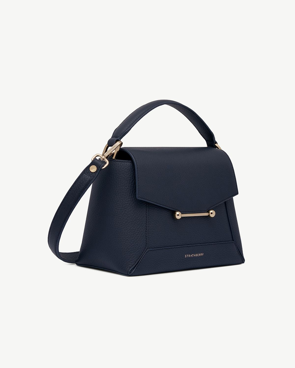 Navy mosaic bag with top handle, shoulder strap and gold bar closure, Strathberry.