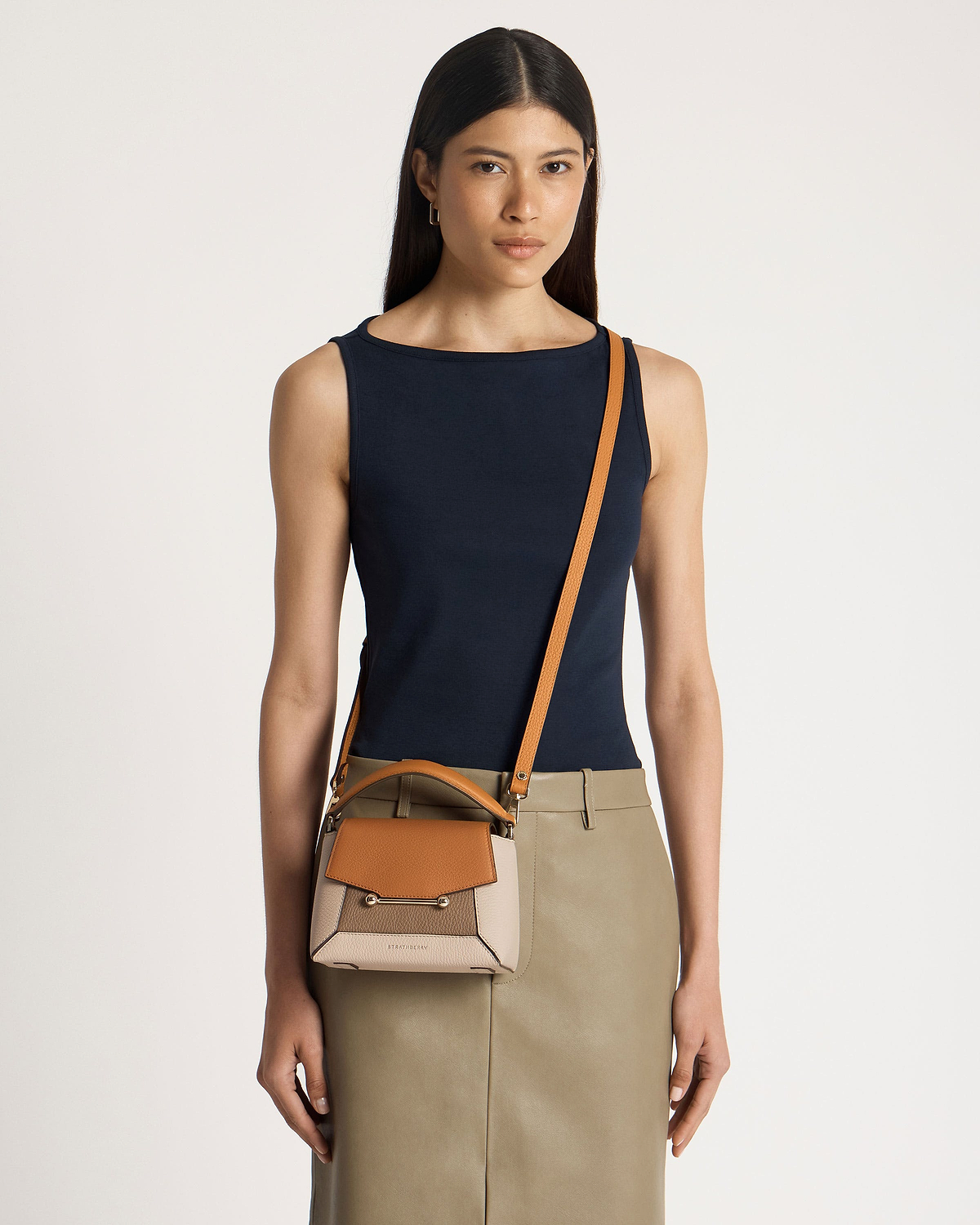 Model wearing Strathberry Mosaic Nano crossbody bag in oat, honey and clay.
