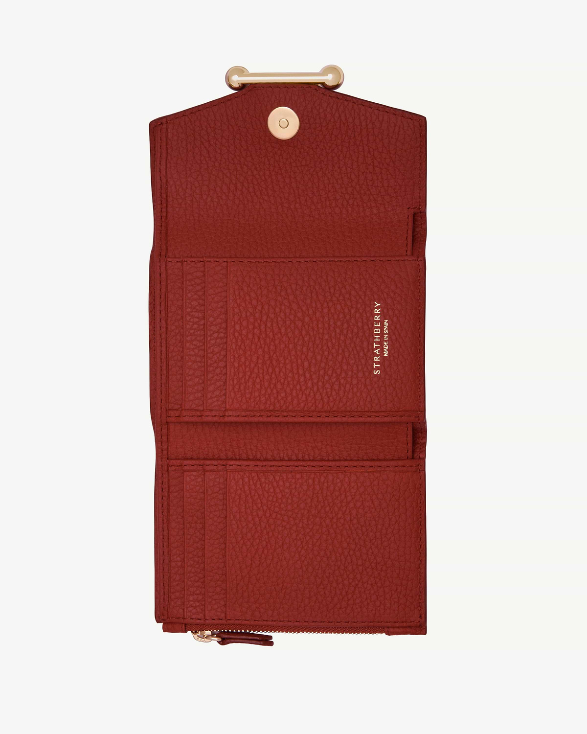 Strathberry Levanto red trifold wallet open, showing card slots and zip pocket.