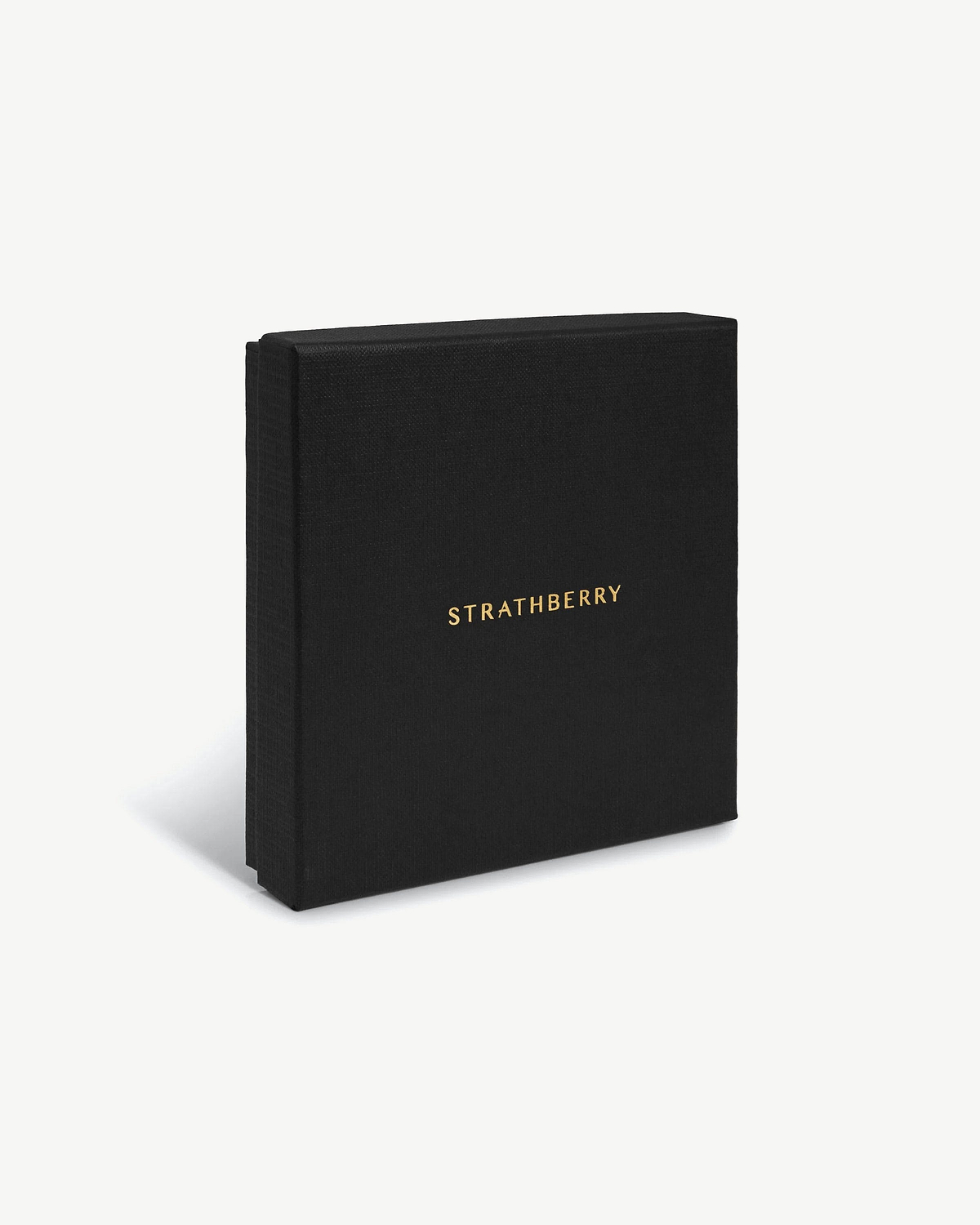 Black textured presentation box with gold Strathberry logo on plain background.