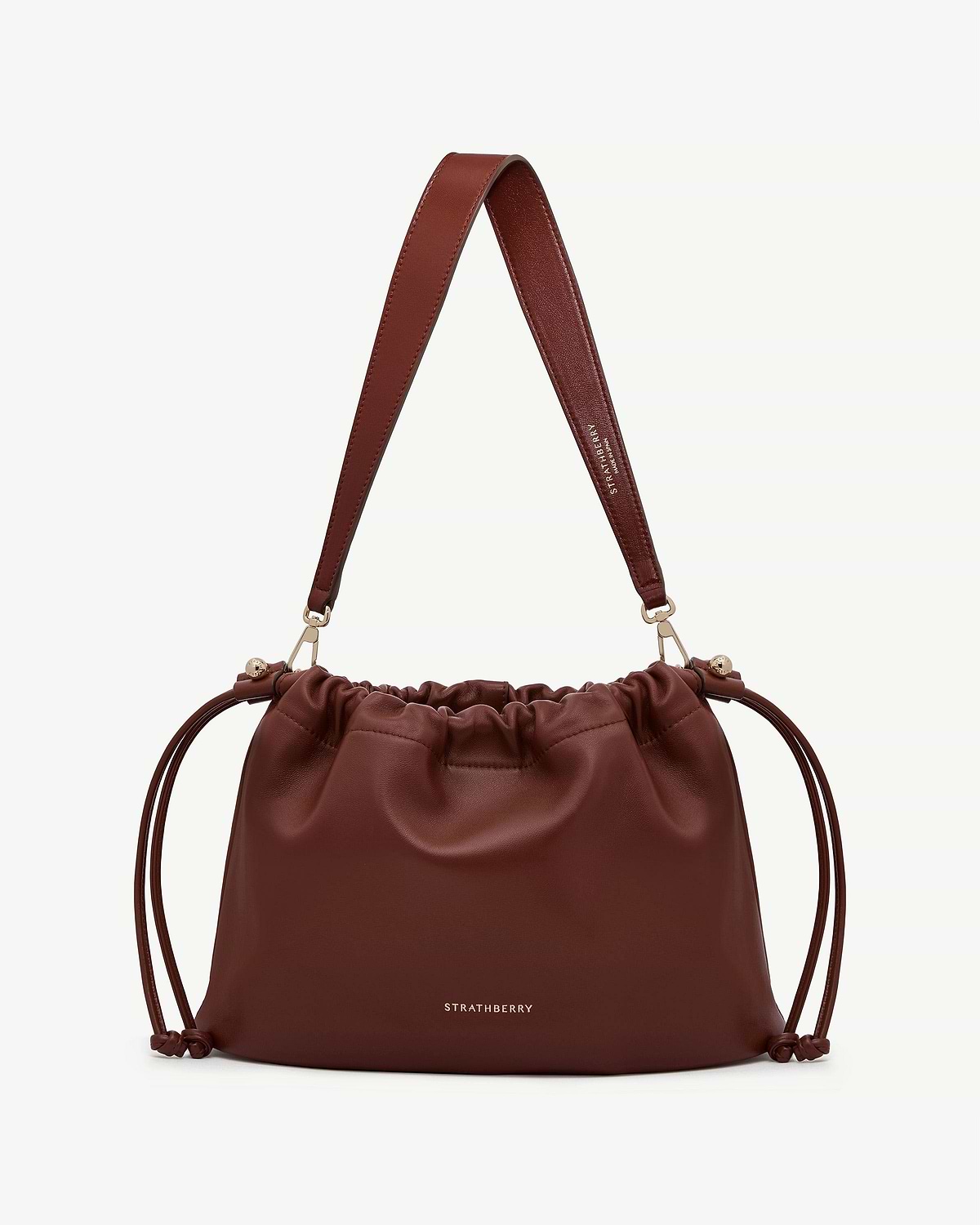 Strathberry Charlotte midi drawstring bag in walnut with leather shoulder strap.