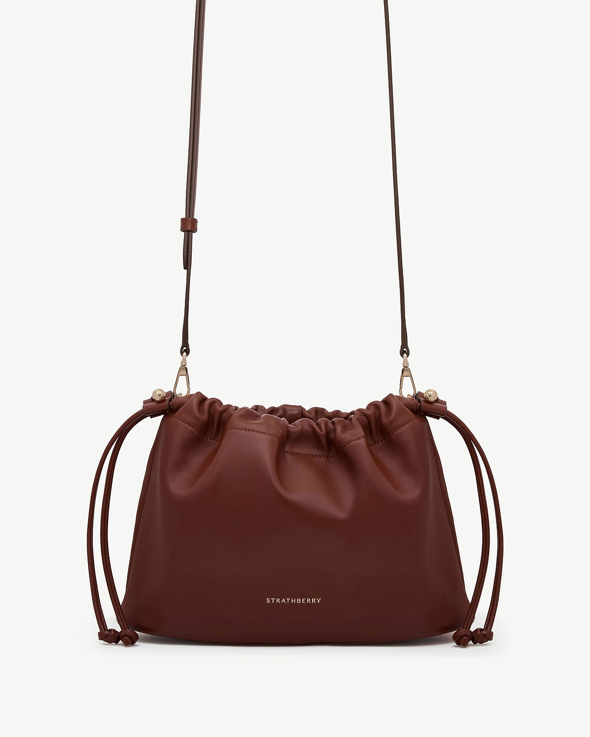 Strathberry Charlotte Midi drawstring bag in walnut leather with gold logo.