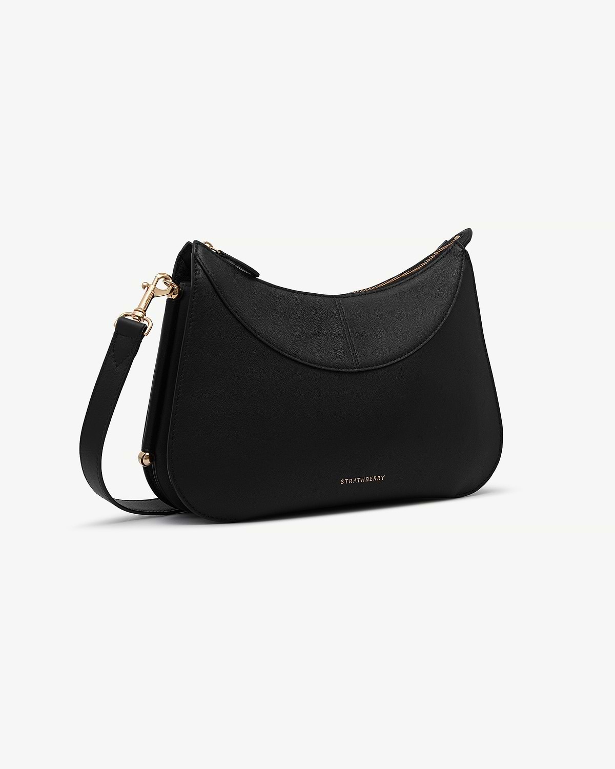 Black Nest shoulder bag with curved top flap, gold hardware, Strathberry logo.