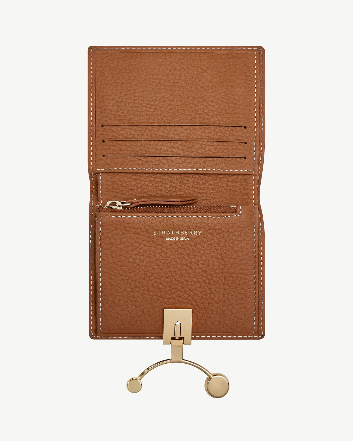 Tan leather crescent wallet open with card slots, zip pocket, vanilla stitching and Strathberry logo.