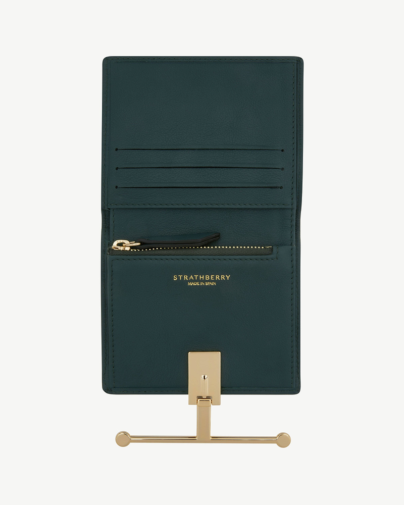 Bottle green Melville Street wallet open, Strathberry logo and gold clasp visible.