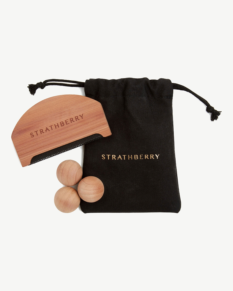 Black Strathberry drawstring bag with wooden brush and three wooden balls