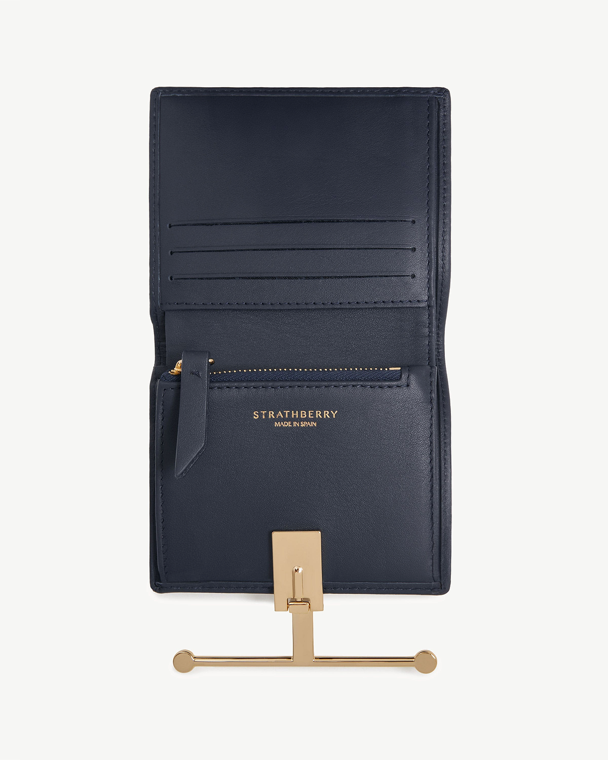 Open marine blue Strathberry Melville Street wallet showing card slots and gold bar closure.