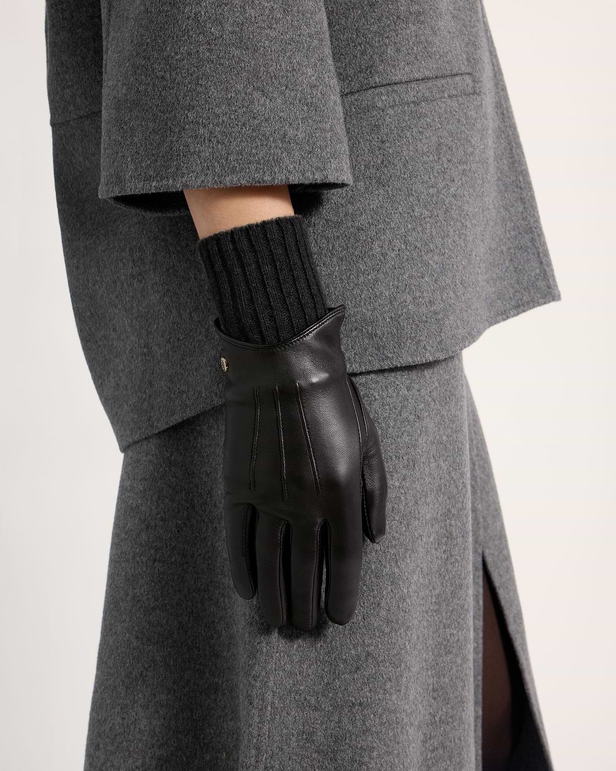 Black leather gloves with ribbed knit cuff worn with grey coat and skirt