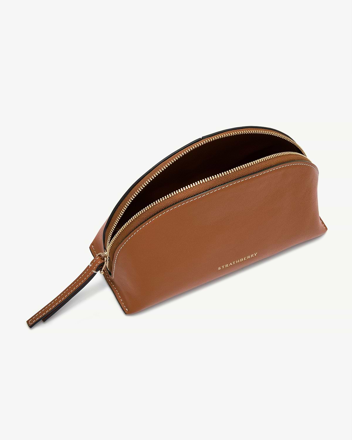 Tan Nest pouch with gold zip, wrist strap and Strathberry logo.