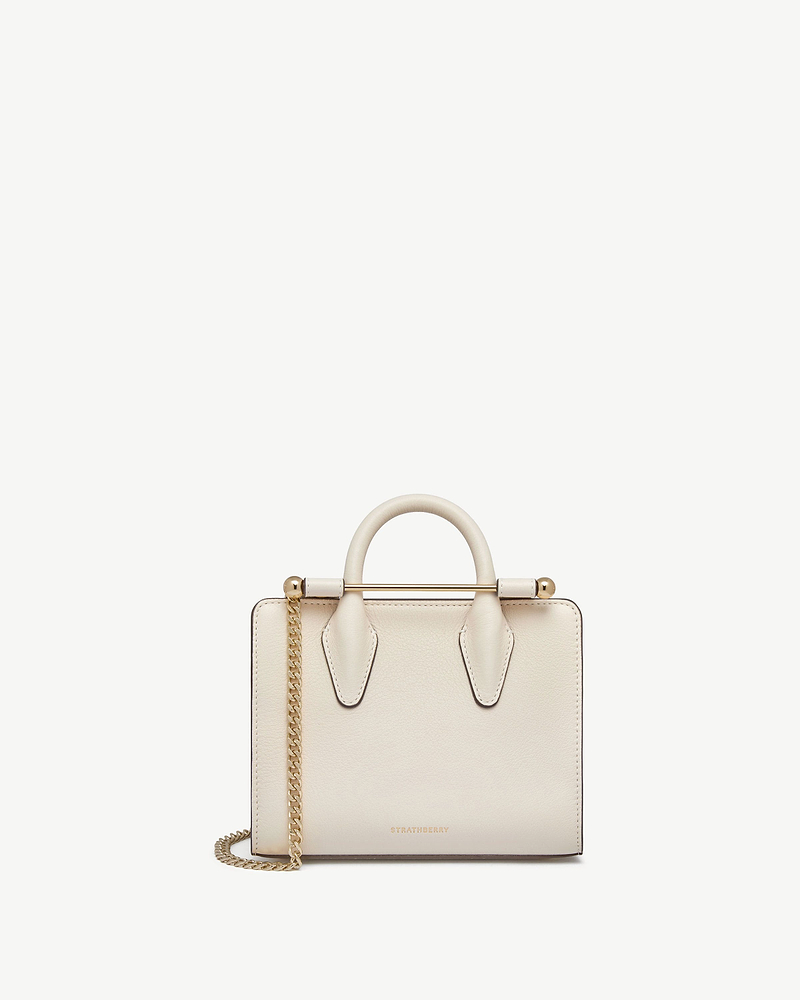 Strathberry vanilla nano tote with top handles, gold bar and chain strap.