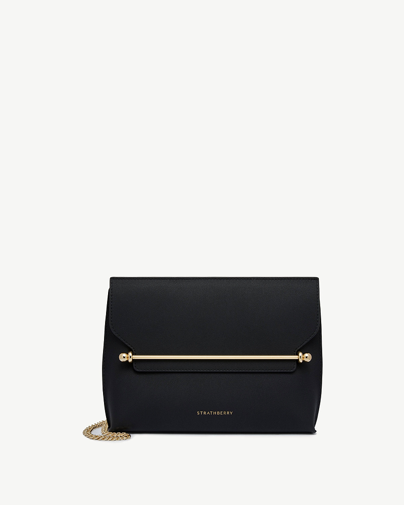 Black Strathberry Stylist leather shoulder bag with gold bar and chain.