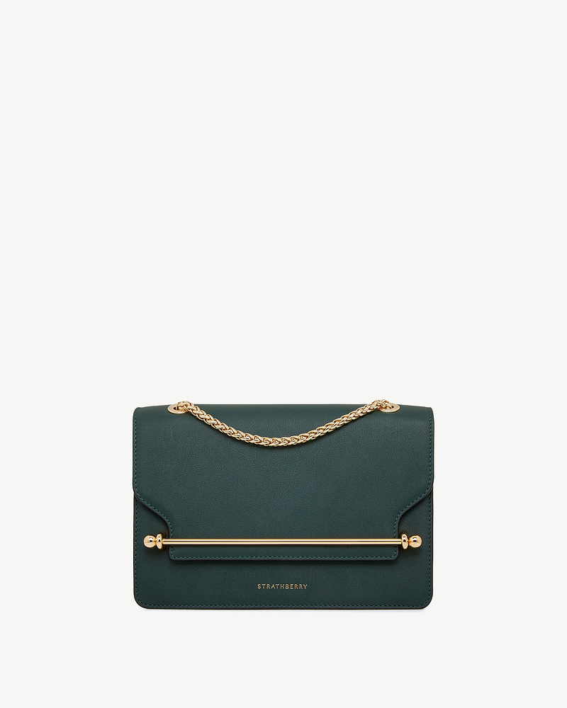 Bottle green East/West leather bag with gold chain strap, bar detail and Strathberry logo.