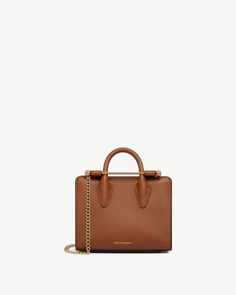 Chestnut leather Strathberry nano tote with top handles, gold bar and chain strap.