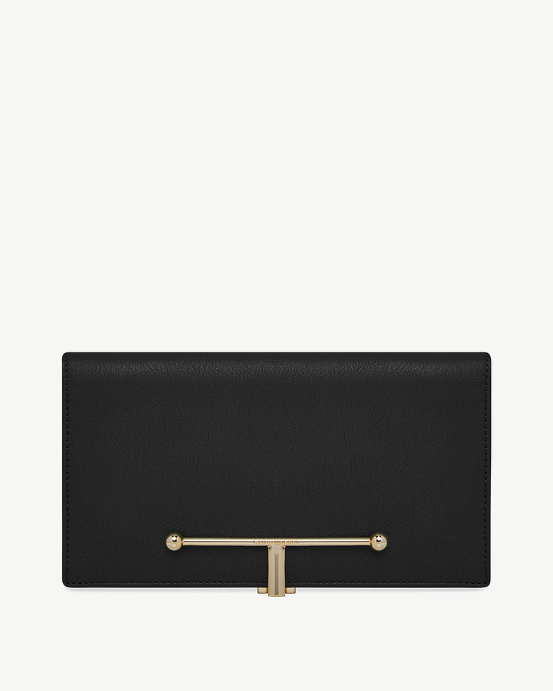 Large black leather wallet with horizontal gold T-bar closure on front.