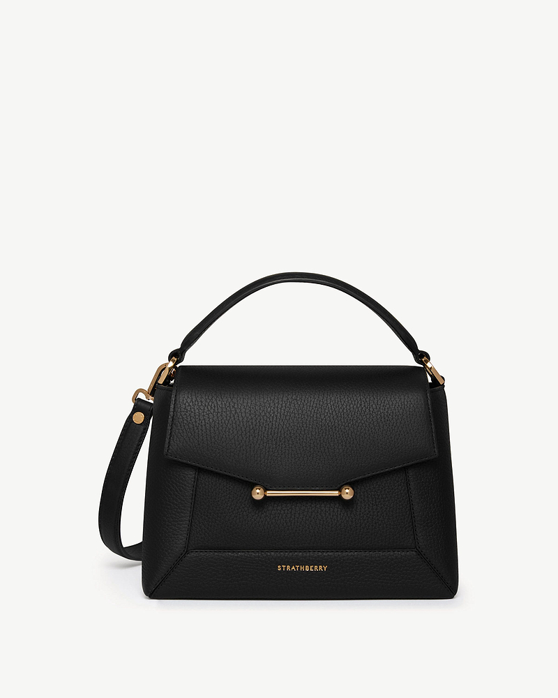 Black Strathberry mosaic bag with top handle, detachable strap and gold bar.