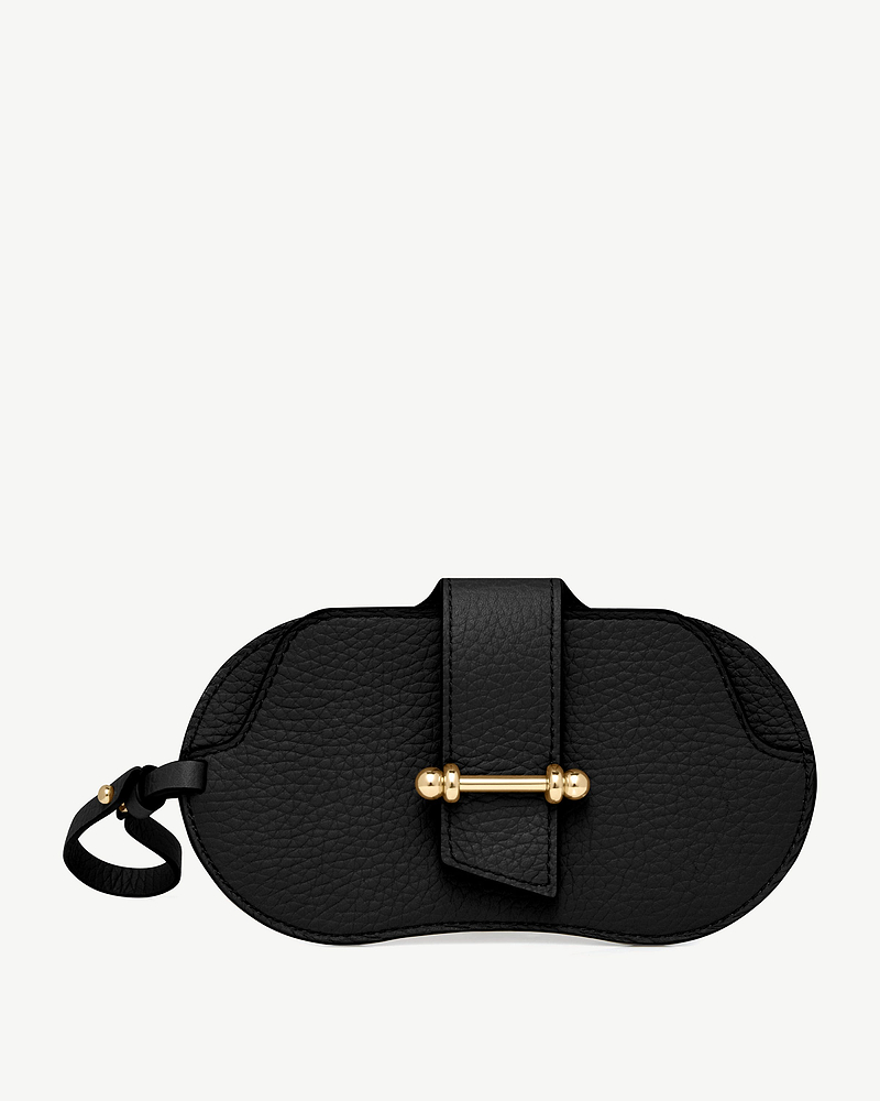 Black pebbled leather sunglasses case with gold bar closure and leather wrist strap