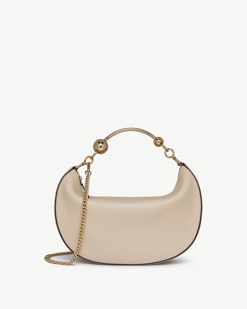 Oat crescent-shaped leather bag with gold chain strap and top handle.