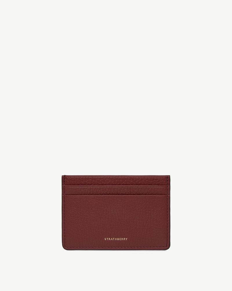 Oxblood leather three-slot cardholder with Strathberry logo embossed in gold.