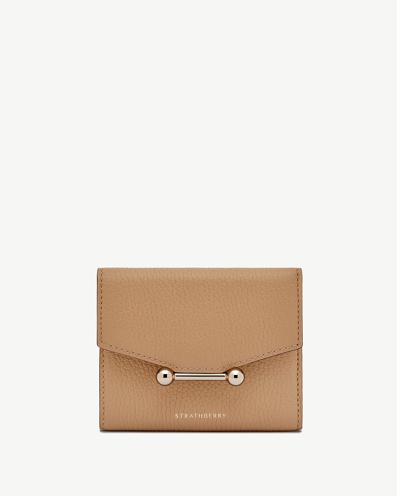 Strathberry mosaic trifold wallet in caramel grained leather with bar fastening.