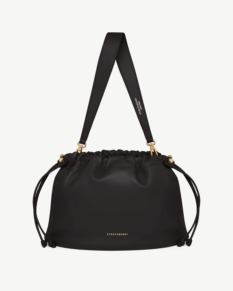Black Strathberry Charlotte Midi drawstring bag with wide shoulder strap and gold hardware