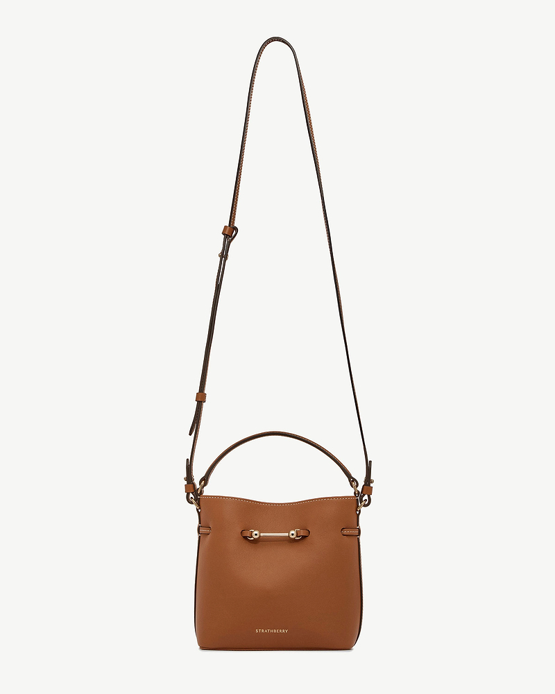 Chestnut leather mini bucket bag with long strap, gold bar hardware, Strathberry logo
