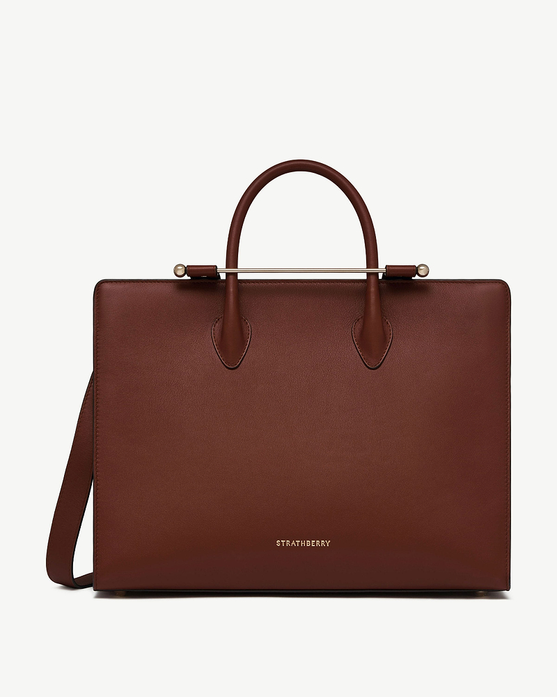 Walnut leather tote with top handles, gold bar and Strathberry logo.