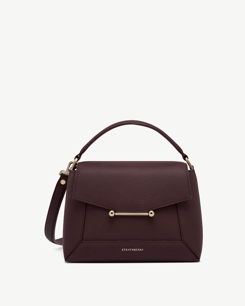 Burgundy mosaic top handle bag with gold bar detail and Strathberry logo.