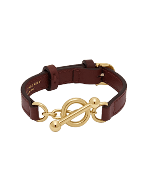 Oxblood leather kite bracelet with gold toggle bar clasp and buckled strap.