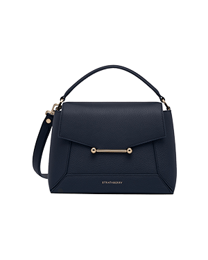 Navy Strathberry Mosaic bag with top handle, shoulder strap, and gold bar detail.