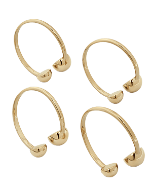Four light gold metal napkin holders with rounded end caps on white background