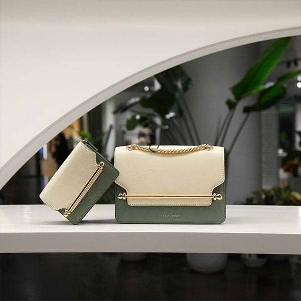 A white and green purse sitting on top of a counter
