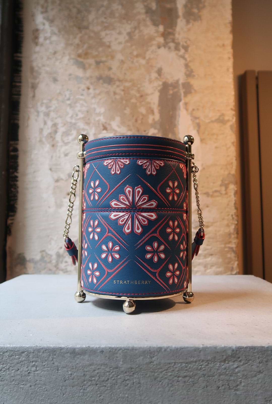 A blue and red bucket sitting on top of a table