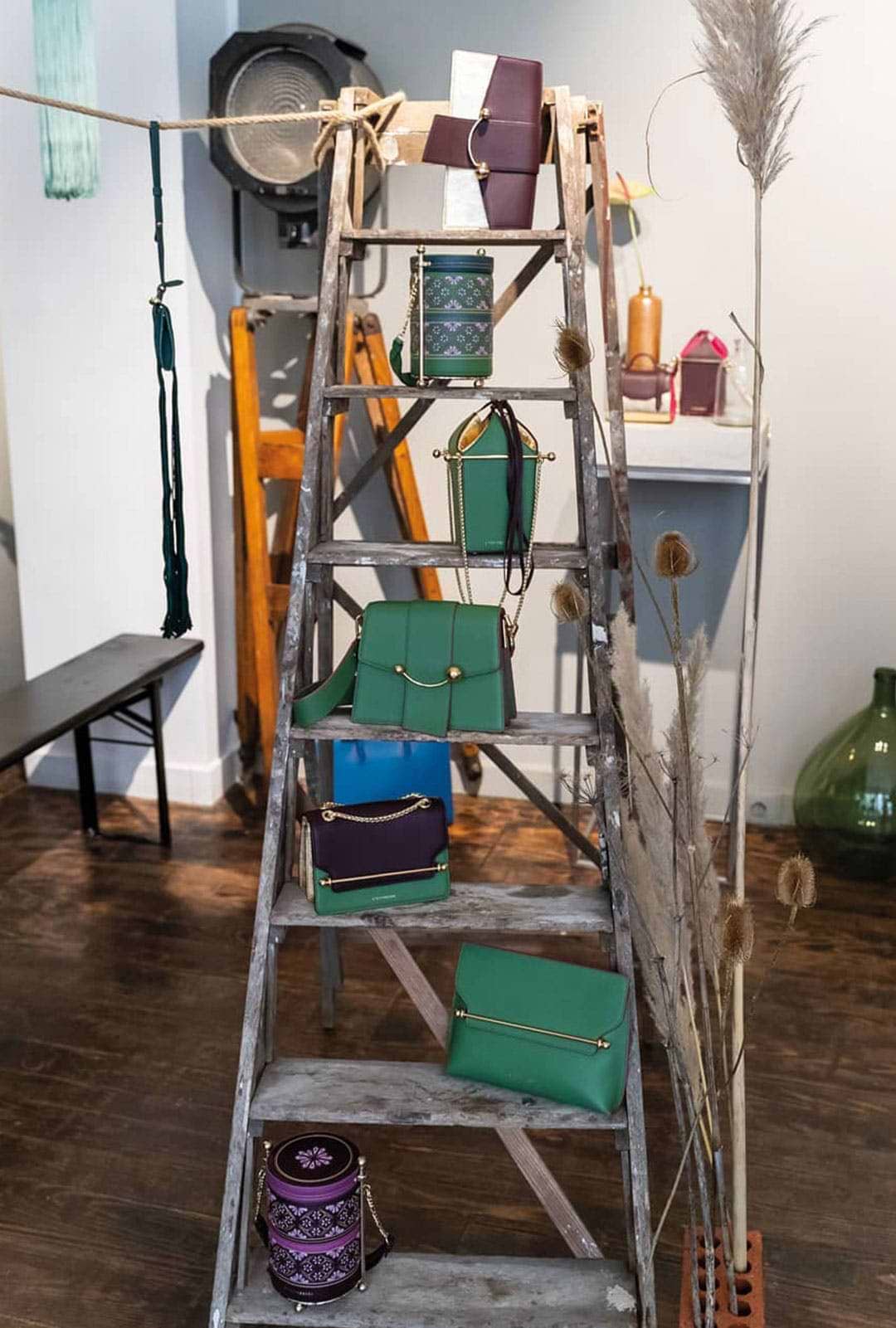 A ladder that has a bunch of bags on it