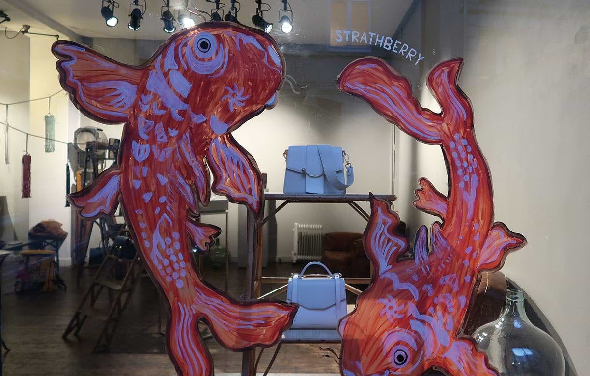 A large red fish sculpture sitting on top of a table
